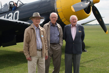 Christopher Cartledge, Keith Quilter and Peter George standing in front of a Corsair