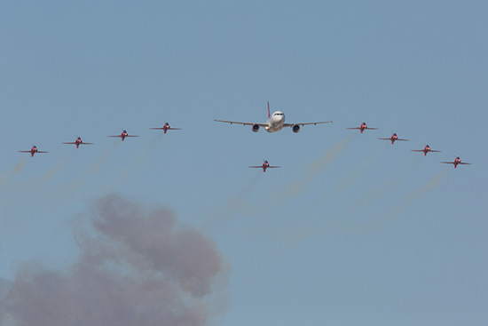 The Red Arrows flypast with a Air Malta Airbus A320 at the Malta Air Show 2014